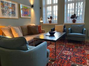 a living room with a couch and chairs and a table at STF Långholmen Hostel in Stockholm