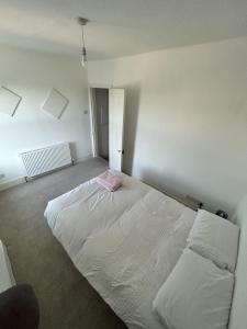 a bedroom with a large white bed and two pillows at Canvas House in Carlisle