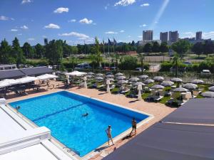 an overhead view of a swimming pool with umbrellas at Hotel Michelino Bologna Fiera in Bologna