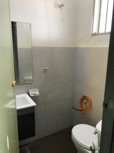 a bathroom with a toilet and a sink at Fidaiy Homestay in Teronoh