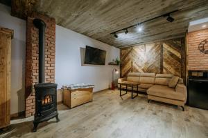 a living room with a couch and a fireplace at Wierch Głodowski 25D by Homeprime in Bukowina Tatrzańska