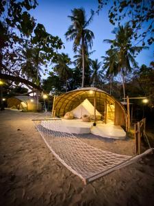 a luxury tent on the beach at night at The Por Beach in Ko Por
