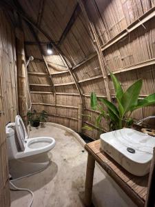 a bathroom with a toilet and a sink in a building at The Por Beach in Ko Por