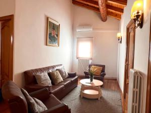 a living room with a couch and a table at Can Florido - L'Amfitriona in Sort +22 photos