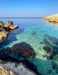 a large body of water with rocks and reefs at La Petite Calanque in Marseille