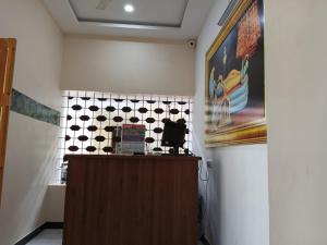 a reception desk in a room with a tile wall at SRI PADMANABHA TOURIST HOME in Chacka