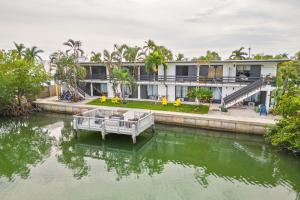 a house with a dock in the water at Capri 108 in Marco Island