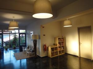 a living room with two lights and a book shelf at Gorgona Hotel in Skála Sykaminéas