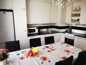 a kitchen with a table with fruit on it at 2 bedroom apartment, Turku in Turku