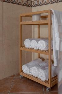 a wooden towel rack with towels in a bathroom at Guest House Štruc in Slovenj Gradec