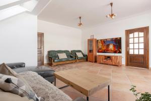 a living room with a couch and a table at Guest House Štruc in Slovenj Gradec