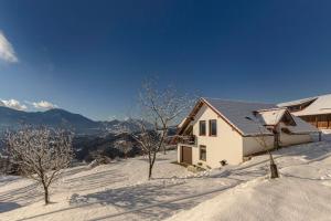 a house on top of a snow covered mountain at Guest House Štruc in Slovenj Gradec