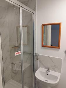 ein Bad mit einer Dusche, einem WC und einem Waschbecken in der Unterkunft Two Birds Weekly Stay in Malmesbury
