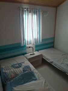 Postel nebo postele na pokoji v ubytování Camping Domaine Vallée du Tarn SN