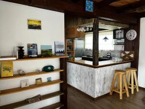 a kitchen with a counter and some wooden stools at Cabaña del Mar en La Paloma in La Paloma