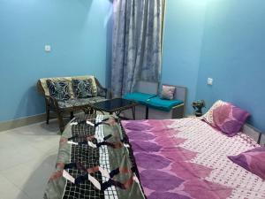 a bedroom with a bed and a table and chairs at Trikuta Homestay in Jammu