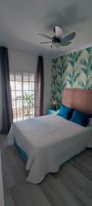 a bedroom with a large bed with a ceiling fan at Apartamentos Ana's Cozy Inns in Torremolinos