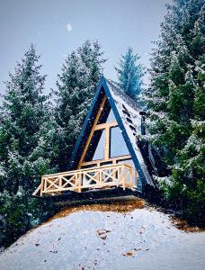 a small wooden bridge with snow on it at Hanina Village Resort - l i ll in Čajniče