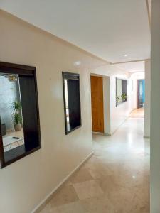 a hallway of a house with white walls at Superbe Appartement à proximité de la corniche in Casablanca