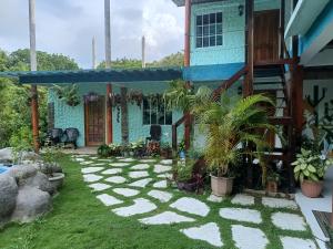 a garden in front of a house at CasaLuna Tayrona in Santa Marta