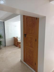 an open wooden door in a living room at Superbe Appartement à proximité de la corniche in Casablanca