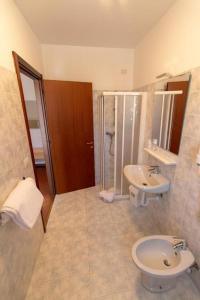 a bathroom with a toilet and a sink at Hotel del Boschetto in Poggiridenti