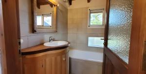 a bathroom with a sink and a tub and a mirror at Chacra Esaki in El Bolsón +38 photos