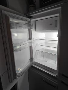 an open refrigerator with its door open and its lights on at Leineblick in Seelze