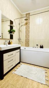 a bathroom with a tub and a sink and a shower at Бухар Жырау Ботанический in Almaty