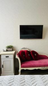 a red couch with pillows on it next to a table at Бухар Жырау Ботанический in Almaty +31 photos