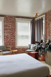 a room with a bed and a brick wall at The Jesse Hotel & Bar in Reno