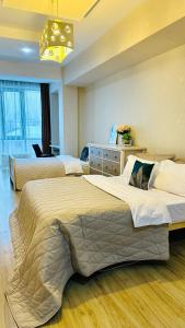 a hotel room with two beds and a chandelier at Бухар Жырау Ботанический in Almaty