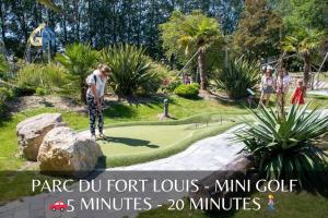 a man is playing golf on a golf course at *Villa Marine*La Vigie - Duplex in Coudekerque-Branche