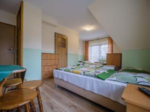 a bedroom with two beds and a table and chairs at U KOMINKA in Zakopane