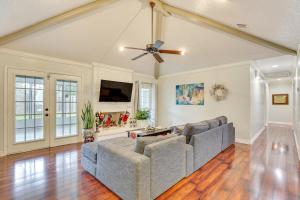 a living room with a couch and a ceiling fan at Houston Home with Screened Porch, Near Sugar Land! in Houston