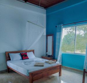 En eller flere senge i et værelse på Lake Bungalow - Sigiriya