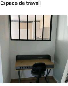 a room with a desk with a chair and a window at La Parenthèse Rémoise in Reims +2 photos