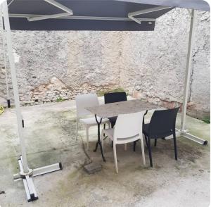 a table and chairs under a tent in a room at La Parenthèse Rémoise in Reims
