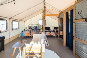 a room with a bed and a couch and a table at Cozy Old West Glamping Walk to Tombstone in Tombstone