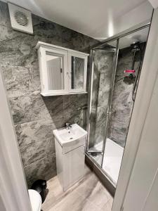 a bathroom with a toilet and a sink and a shower at Newly refurbished flat Colwyn Bay in Colwyn Bay