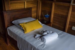 a bed with a baby doll laying on it at Wanakaset Forest Glamping in Kitulgala