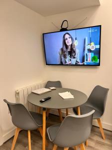 a meeting room with a table and a tv on the wall at Newly refurbished flat Colwyn Bay in Colwyn Bay