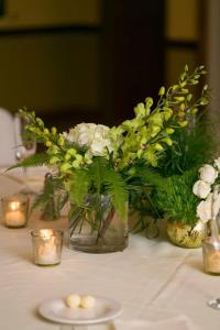 a vase filled with white flowers on a table at Hilton Scranton & Conference Center in Scranton