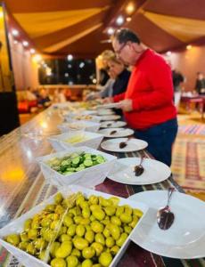 a buffet with plates of food on a table at Star Magic Camp in Wadi Rum