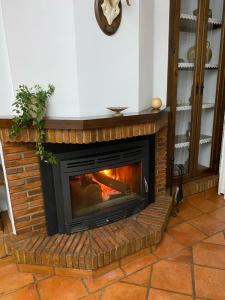 a fireplace in a living room with a fire place at Casa Rural Mijarra **** in Herrera del Duque