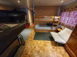 a room with two bunk beds and a counter at Chalet ALOA in Le Bonhomme