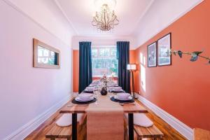 a dining room with a long table with plates and dishes at Huge House in Leeds 6BR sleeps13 by PureStay Short Lets in Meanwood