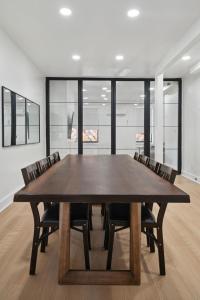 a dining room with a large wooden table and chairs at Fishtown Photo Shoot and Meeting Space in Philadelphia