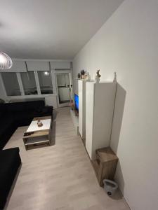 a small living room with a table and a refrigerator at Aki Apartment in Zagreb