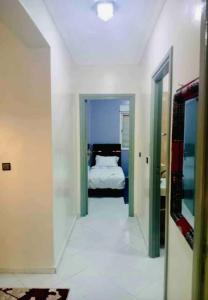 a hallway leading to a bedroom with a bed at the best appartement in Taza